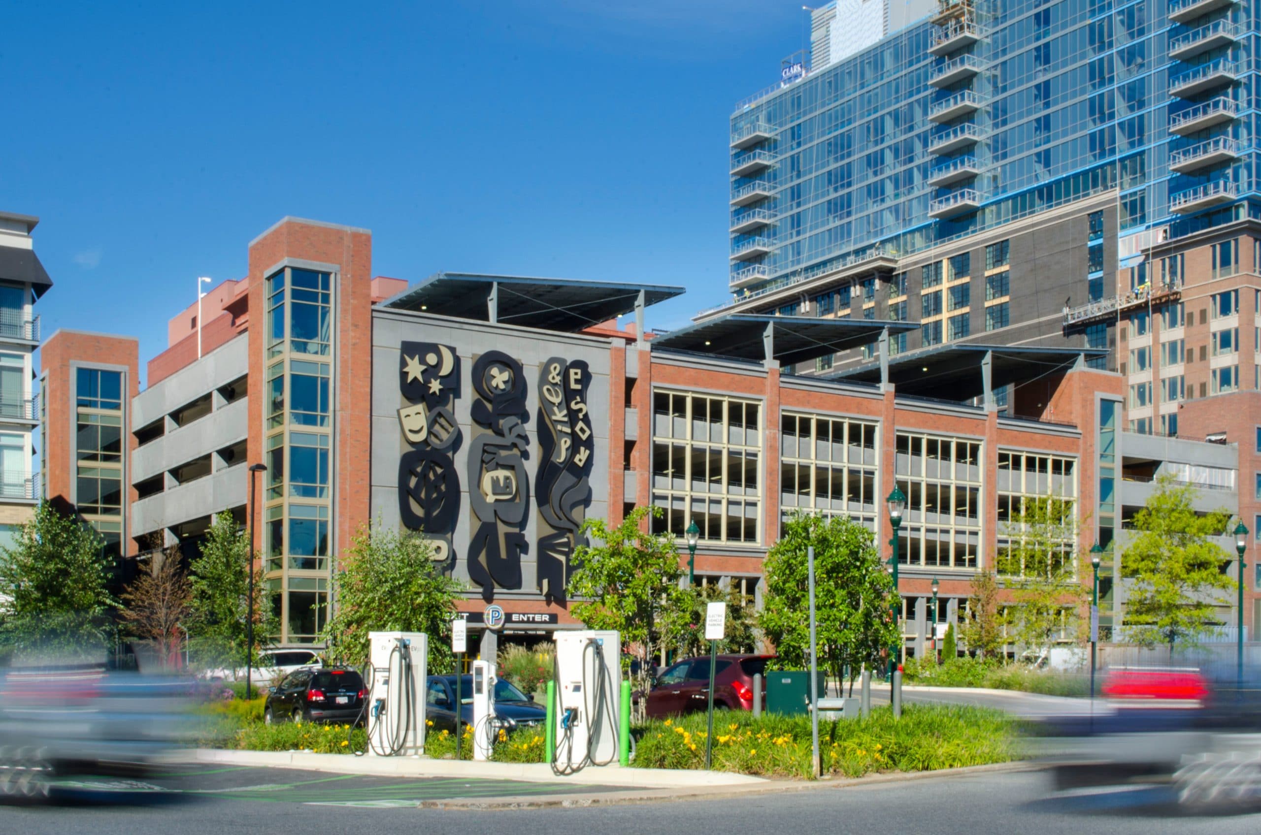 car charging stations in front of pike and rose garage with solar panels